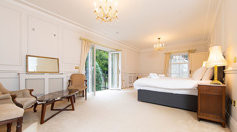 Master bedroom at yoga retreat with woodland views